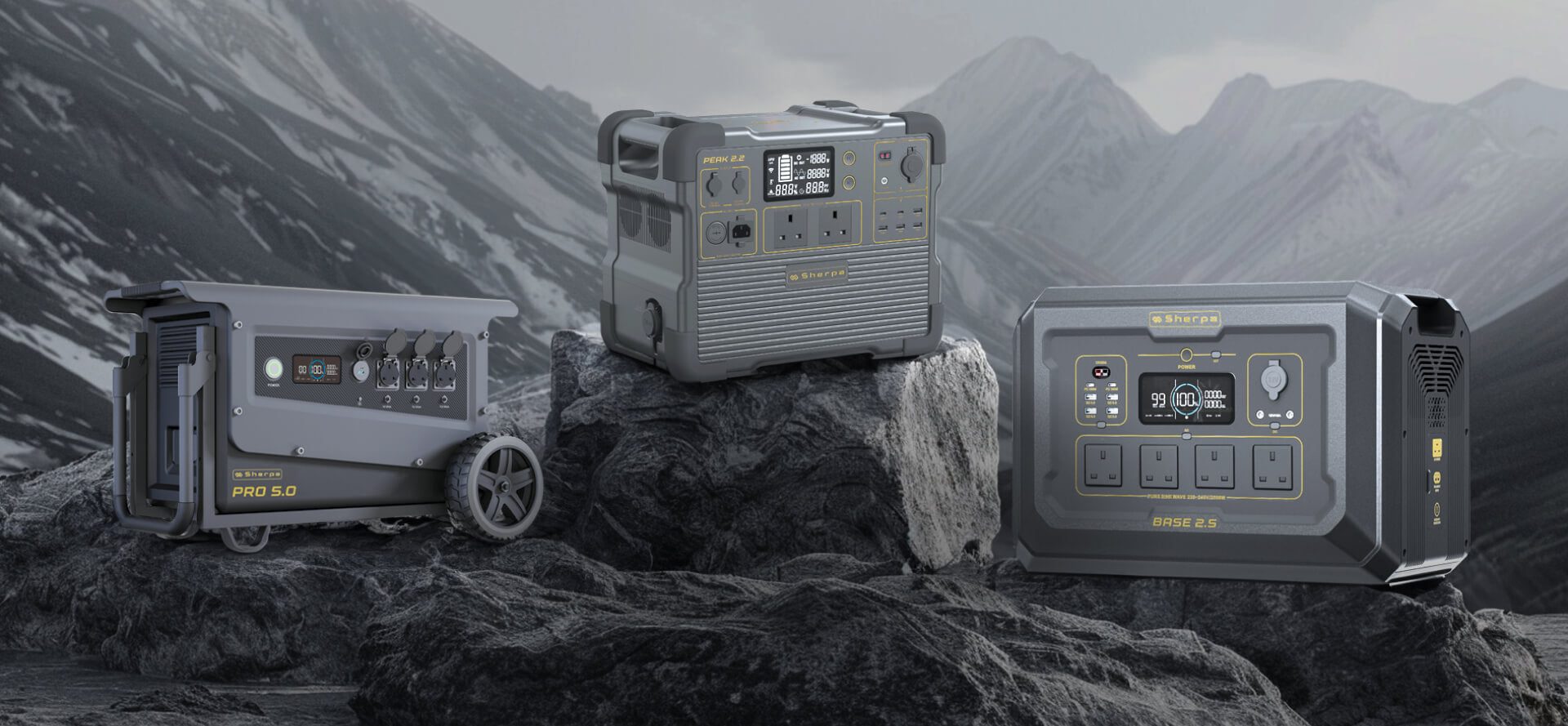 Showcasing three portable power stations in the foreground on a rocky surface with a snowy mountain range backdrop