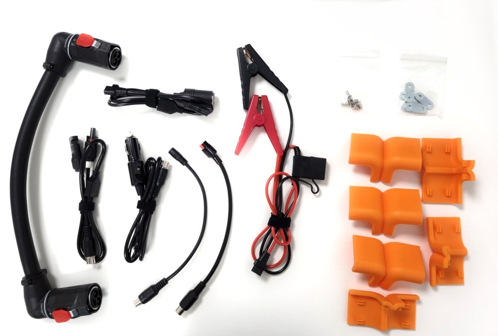 Overhead shot of accessory cables included: expansion link cable, car charger, crocodile clips, solar cables and fixings